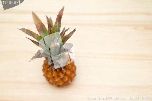 Image of fresh pineapple on the wooden table
