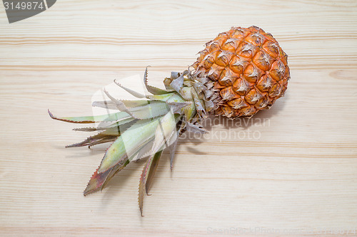 Image of fresh pineapple on the wooden table