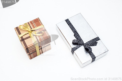 Image of brown and silver gift box with bow on white background