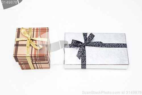 Image of brown and silver gift box with bow on white background