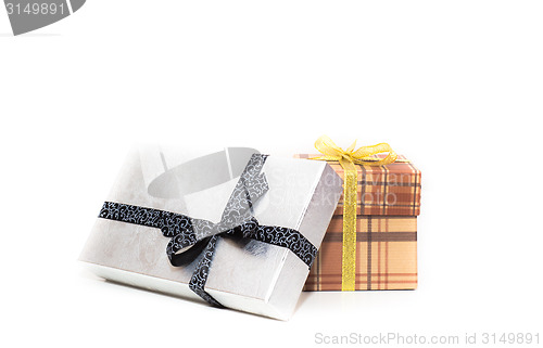 Image of brown and silver gift box with bow on white background