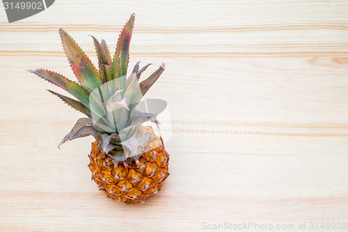 Image of fresh pineapple on the wooden table