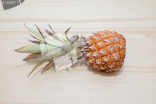 Image of fresh pineapple on the wooden table