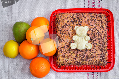 Image of Delicious cake on a platter and fruit.