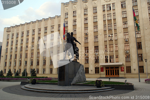 Image of Man horseback and building