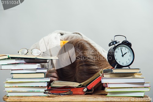 Image of girl student with glasses reading books