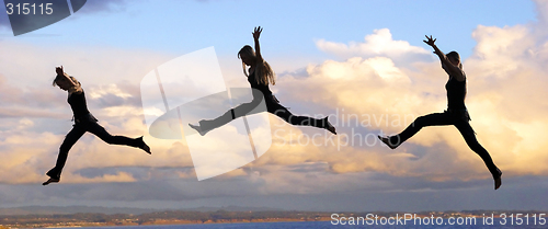 Image of Leaping woman at sunset