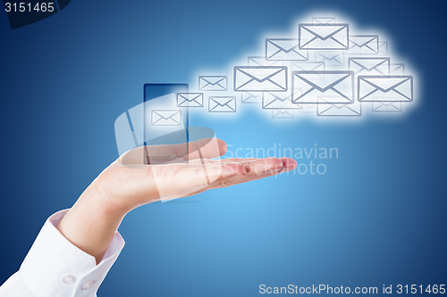 Image of Email Cloud Leaving Smart Phone Over Blue Ground