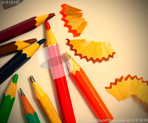 Image of several vintage pencils and shavings on white