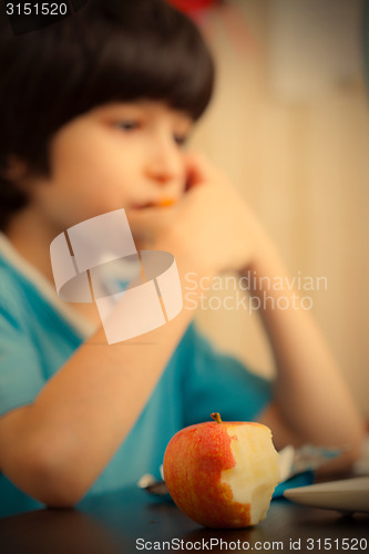 Image of bitten apple and a boy with computer
