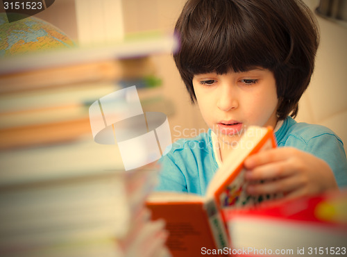 Image of boy reading a book