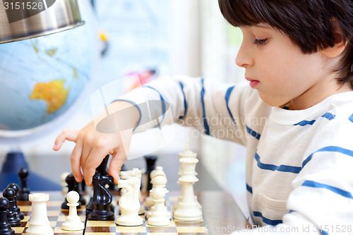 Image of boy playing a game of chess