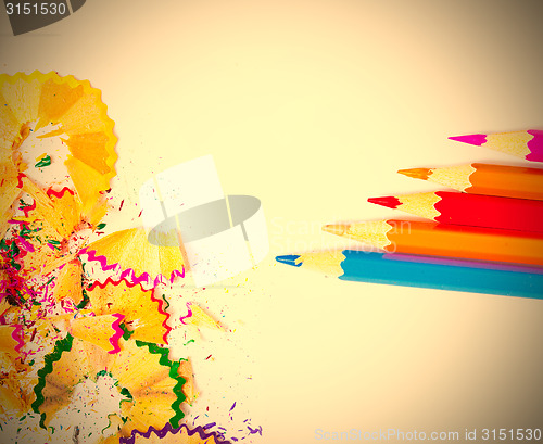 Image of colored pencils and shavings on white background
