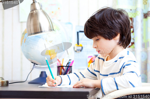 Image of schoolboy doing homework