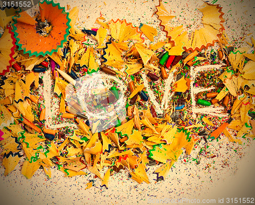 Image of The word Love on colored pencil shavings