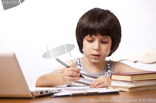 Image of schoolboy does his homework