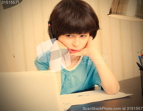 Image of boy looks thoughtfully at the display