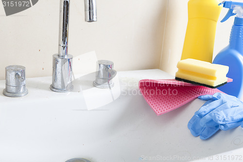 Image of dirty sink and cleaning products