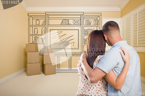 Image of Military Couple In Empty Room with Shelf Drawing on Wall