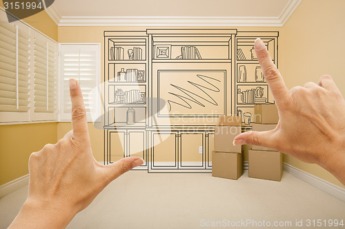 Image of Framing Hands In Empty Room with Shelf Drawing on Wall