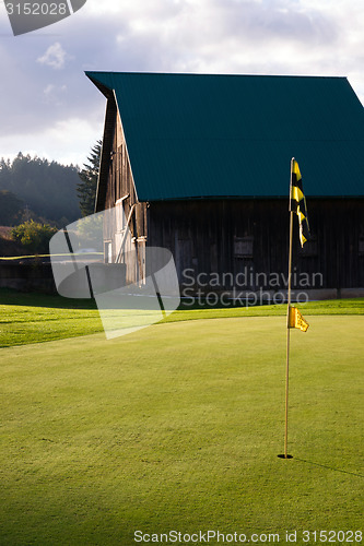 Image of Cloudy Sky Over Rural Barn County Golf Course