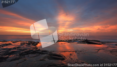 Image of Streaks of orange red light at sunrise Curl Curl