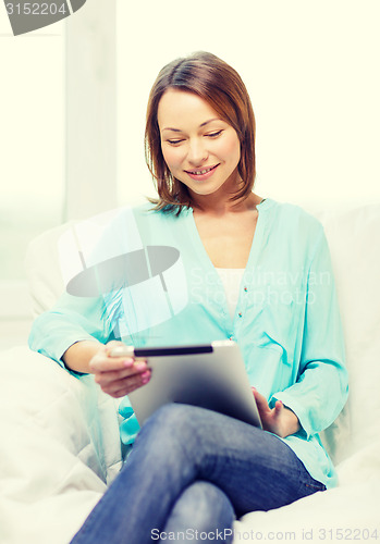 Image of smiling woman with tablet pc computer at home