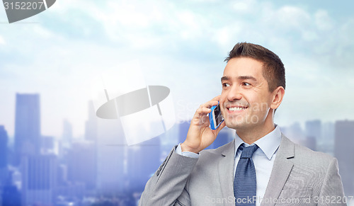 Image of happy businessman calling on smartphone