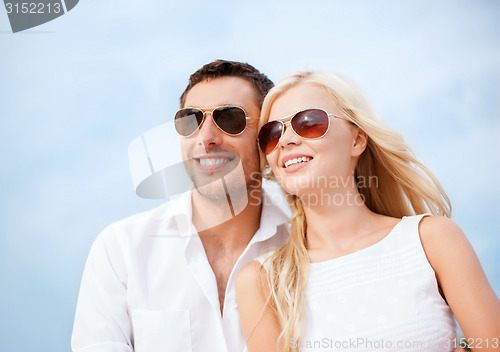 Image of couple in shades at sea side