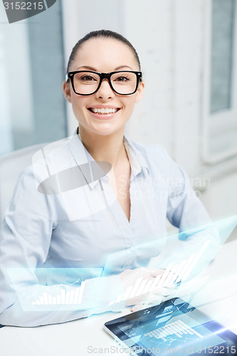 Image of smiling businesswoman in eyeglasses with tablet pc