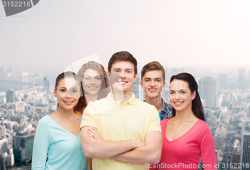 Image of group of smiling teenagers over city background