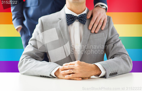 Image of close up of male gay couple with wedding rings on