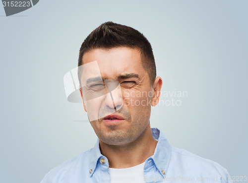 Image of man wrying of unpleasant smell