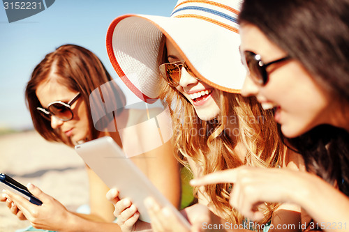 Image of girls with tablet pc on the beach