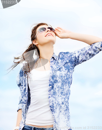 Image of teenage girl in shades outside