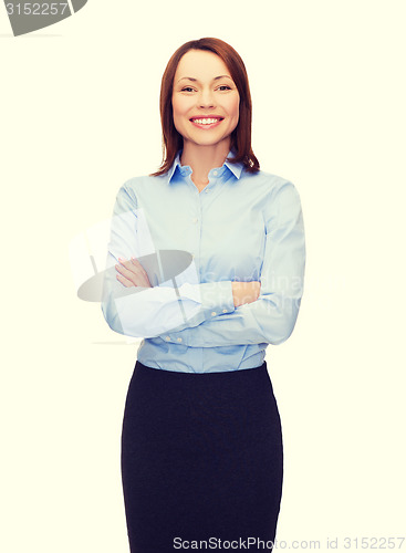 Image of young smiling businesswoman with crossed arms