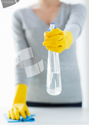 Image of close up of woman cleaning table with cloth