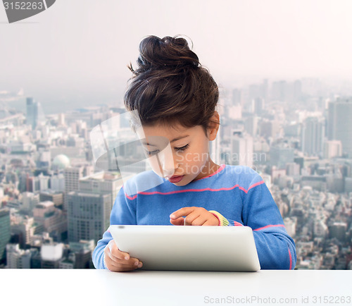 Image of little girl with tablet pc over city background