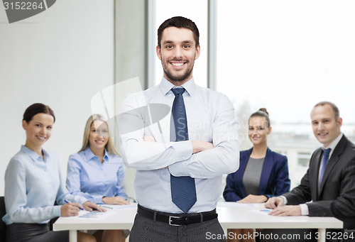 Image of handsome businessman with crossed arms