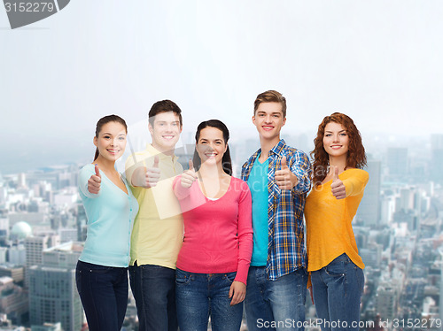 Image of group of smiling teenagers over city background