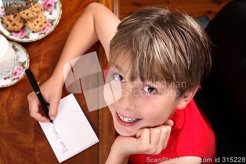 Image of Child writing  a letter or card at Christmas