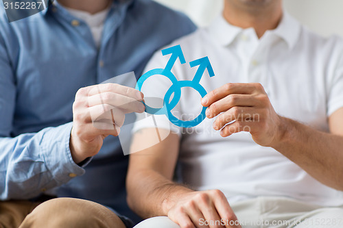 Image of close up of happy male gay couple with love symbol