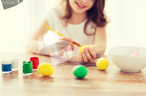 Image of close up of girl coloring eggs for easter