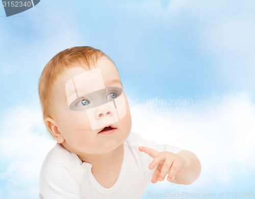 Image of curious baby looking side