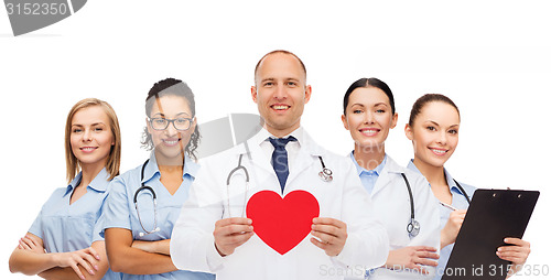 Image of group of smiling doctors with red heart shape