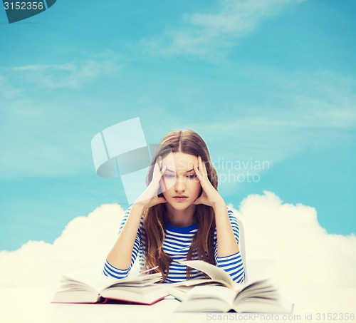 Image of stressed student girl with books