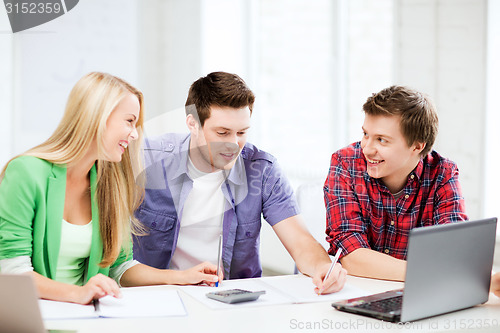 Image of students chatting in lecture at school