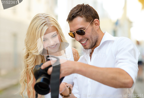 Image of smiling couple with photo camera