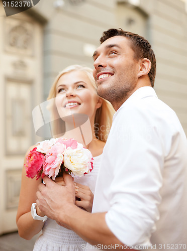 Image of couple with flowers in the city