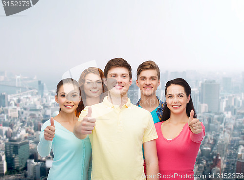 Image of group of smiling teenagers over city background